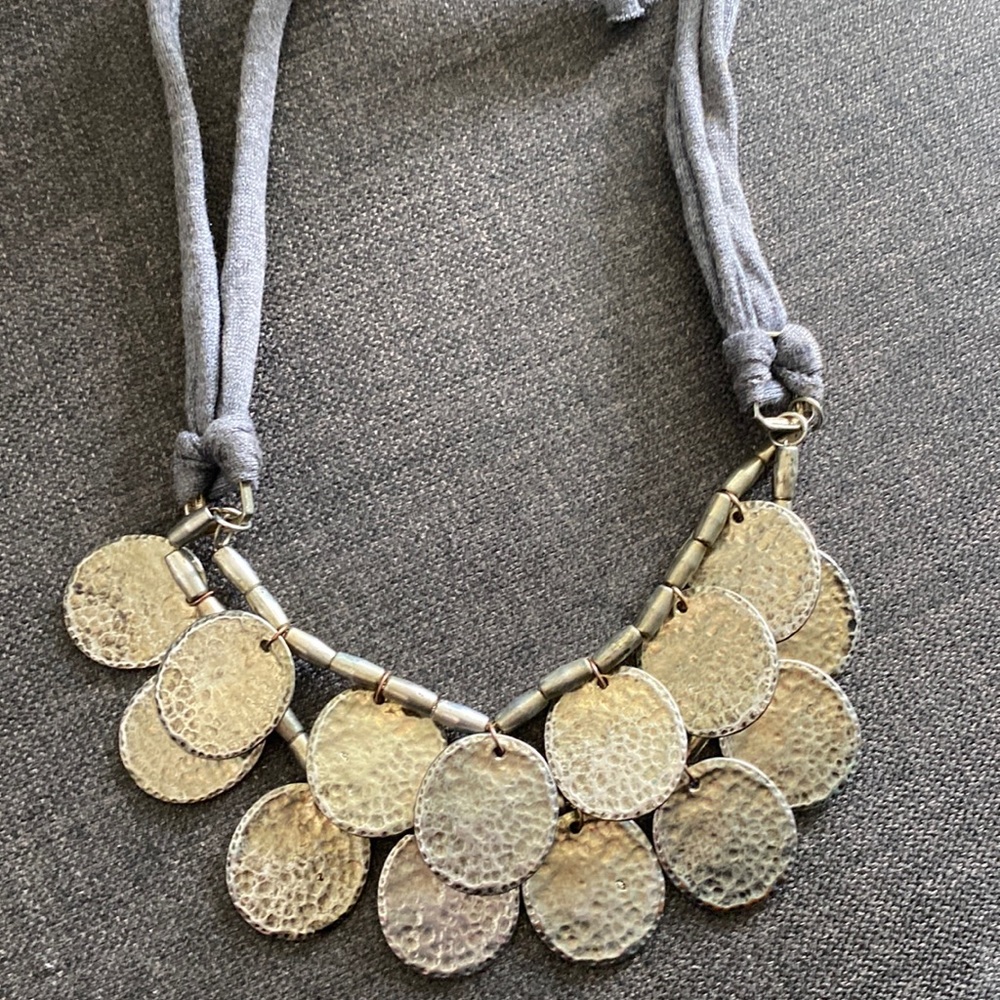 Anthropologie coin necklace on grey jersey closure.